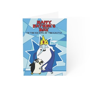 May include: A Father's Day greeting card featuring the Ice King and a penguin from Adventure Time. The card has a blue geometric background and the text "Happy Father's Day to the Ice King of the Castle" in red and blue.