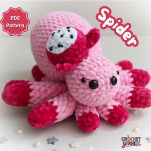 May include: A handmade pink crochet spider toy with a dragon fruit accent. The spider has eight legs with dark pink tips and black eyes. The word "Spider" is written in pink on the upper right. The image also includes the text "PDF Pattern".