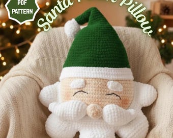May include: A crocheted Santa Claus plush pillow with a green hat, white trim, and a white beard. The pillow is beige with rosy cheeks and closed eyes. The words "Santa Plush Pillow" are arched above the pillow.