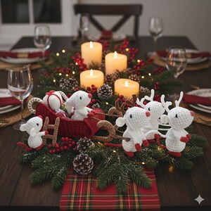 May include: A festive Christmas centerpiece featuring a red crocheted sleigh pulled by white crocheted mice with red accents. The centerpiece includes lit candles, pinecones, greenery, and red berries, creating a warm holiday atmosphere.
