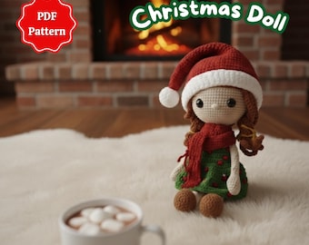 May include: A crocheted Christmas doll wearing a red and white Santa hat, a red scarf, and a green dress with red berry accents. The doll is sitting on a white rug, with a cup of hot chocolate in the foreground. The image also includes the text "Christmas Doll" and "PDF Pattern".