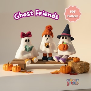 May include: Three crocheted ghost figures, each with unique accessories: a bow, a hat, and a witch hat. The ghosts are on a wooden platform with pumpkins and fall leaves. The text "Ghost Friends" is above them.