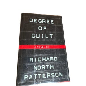 May include: A hardcover book titled "Degree of Guilt" by Richard North Patterson. The book has a black cover with white text and a red stripe across the middle. The book is a novel.