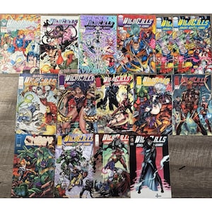May include: A collection of WildC.A.T.S. comic books, featuring vibrant covers with action-packed illustrations. The comics showcase various characters in dynamic poses, with bold colors and detailed artwork. The titles include "Covert Action Teams" and "Jim Lee".