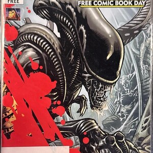 May include: A comic book cover for "Aliens" featuring a detailed illustration of an alien creature with a menacing expression. The cover includes the text "FREE COMIC BOOK DAY" and the Dark Horse Comics logo. Red splatters add a dramatic effect.