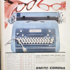 May include: Vintage advertisement for the Smith-Corona Electric typewriter. The image features a light blue typewriter with a white keyboard, and two pairs of eyeglasses. The text reads "See the Smith-Corona Electric before you buy!"