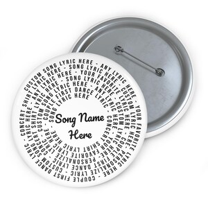 May include: A round white pin-back button featuring black text arranged in a circular pattern. The centre displays the words Song Name Here in a script font, surrounded by repeated phrases including Custom Song Lyric Here and First Dance Lyric.