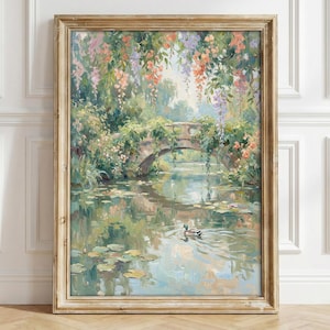 May include: A framed painting depicts a serene waterscape with a stone bridge. Lush greenery and colorful flowers cascade over the bridge and surrounding the water. The painting's soft colors and brushstrokes create a tranquil, impressionistic scene. A duck swims in the water.