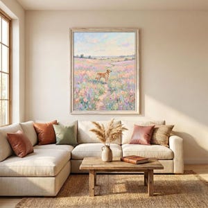 May include: A framed vertical wall art print featuring an impressionistic painting of a golden dog standing in a vast, colorful wildflower meadow under a soft, pastel-toned sky. The artwork is displayed in a light-colored wooden frame.