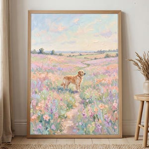 May include: An oil painting in a light wood frame depicting a golden dog standing on a dirt path in a field of pastel pink, purple, and blue wildflowers under a soft sky. The textured brushstrokes create a vibrant landscape scene.