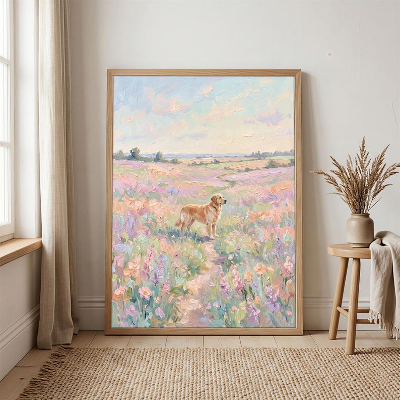 May include: A framed painting shows a golden retriever in a field of wildflowers. The artwork uses a soft, impressionistic style with pastel colours, a winding path, and a light wooden frame.