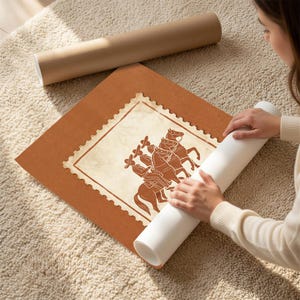 May include: A square poster with a burnt orange background featuring a central cream-colored postage stamp design. The stamp contains a brown illustration of three figures wearing sombreros and riding horses in a line, set against a textured paper background.