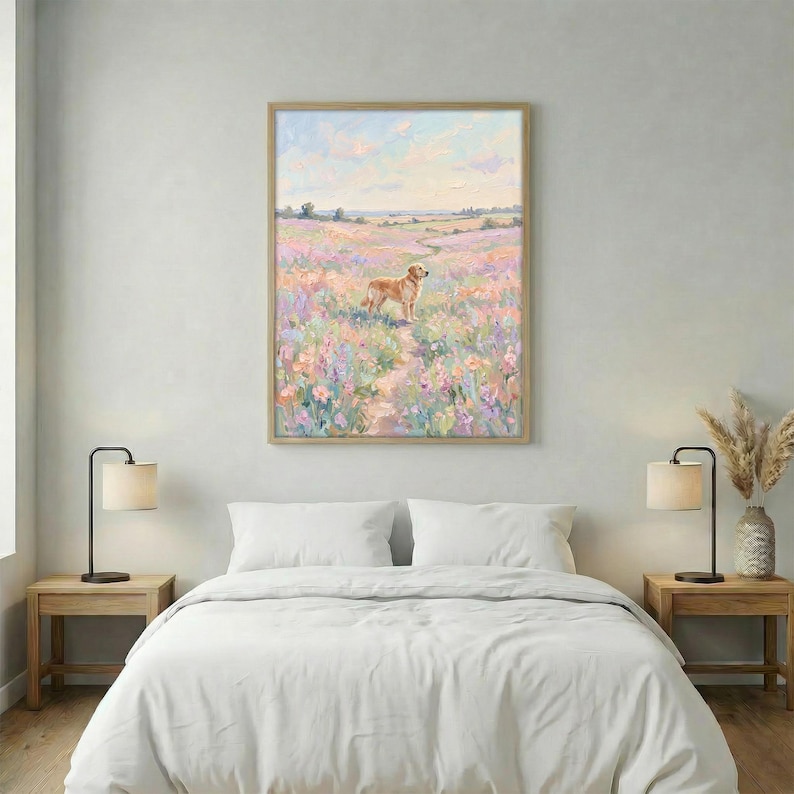 May include: A framed painting shows a golden retriever in a field of wildflowers. The artwork uses a pastel colour palette with a light blue sky and a path. The frame is light wood. The painting is a decorative piece for a bedroom.