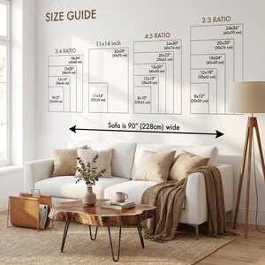 May include: A size guide chart on a white wall above a white sofa, displaying various print dimensions in inches and centimeters for 3:4, 11x14, 4:5, and 2:3 ratios. The text indicates a sofa width of 90 inches, with a wooden coffee table below.