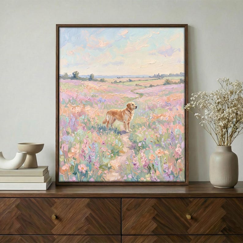 May include: An oil painting in a dark brown frame shows a golden retriever in a field of wildflowers. A path winds through the flowers under a pastel sky. The artwork evokes a sense of peace and tranquility.