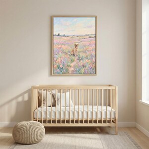 May include: A framed painting depicts a golden retriever sitting in a field of colorful flowers. The artwork features a soft, impressionistic style with pastel hues of pink, purple, and blue. The painting is displayed above a light wood crib.