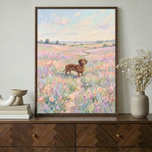 May include: A framed oil painting depicts a brown dachshund standing in a field of colorful wildflowers. The artwork features a path leading through the flowers, with a soft, pastel color palette and a serene landscape in the background.