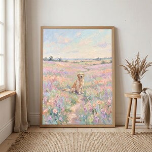 May include: A framed painting of a golden retriever dog sitting in a field of colorful flowers. The artwork features a light brown wooden frame and a pastel color palette of pinks, purples, and blues, evoking a serene, natural scene.