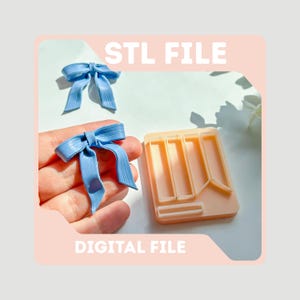 May include: Light blue bow-shaped decorations and a peach-colored mold. The mold has a rectangular shape with several rectangular cutouts. The text "STL FILE" and "DIGITAL FILE" are displayed in white.