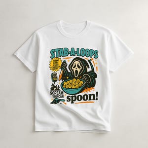 May include: White t-shirt featuring a cartoon graphic of the Ghostface character from the Scream movies. The graphic includes the text "STAB-A-LOOPS" and "Scream you can spoon!" with a bowl of smiley face cereal.