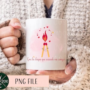 May include: White ceramic mug with a pink and white background. The mug has a graphic of two matchsticks with a flame on top. The text on the mug reads "Eres la chispa que enciende mi corazon".