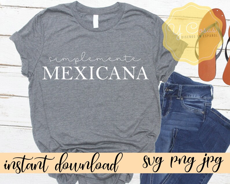 May include: Gray t-shirt with the text "simplemente MEXICANA" in white. The shirt is on a wooden surface with a pair of brown sandals and blue jeans.