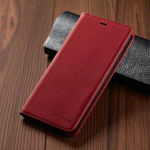 May include: A red leather phone case with a stitched border. The case is closed and has the word "Forweny" embossed on the front. The case is resting on a wooden surface.