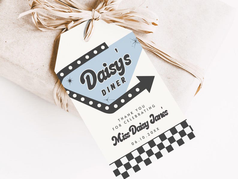 May include: A gift tag with a retro diner theme. The tag features the text "Daisy's Diner" in a stylized font, with a light blue background and a black arrow. The tag also includes the text "Thank you for celebrating, Miss Daisy Janes" and a checkered pattern.