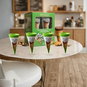 May include: An image of Dubai Cones ice cream cones. The cones are green and white with the brand name on them. The box says "AWESOME" and "WAFER CONES WITH MILK CHOCOLATE, KATAIFI PIECES AND PISTACHIO CREAM FILLING."