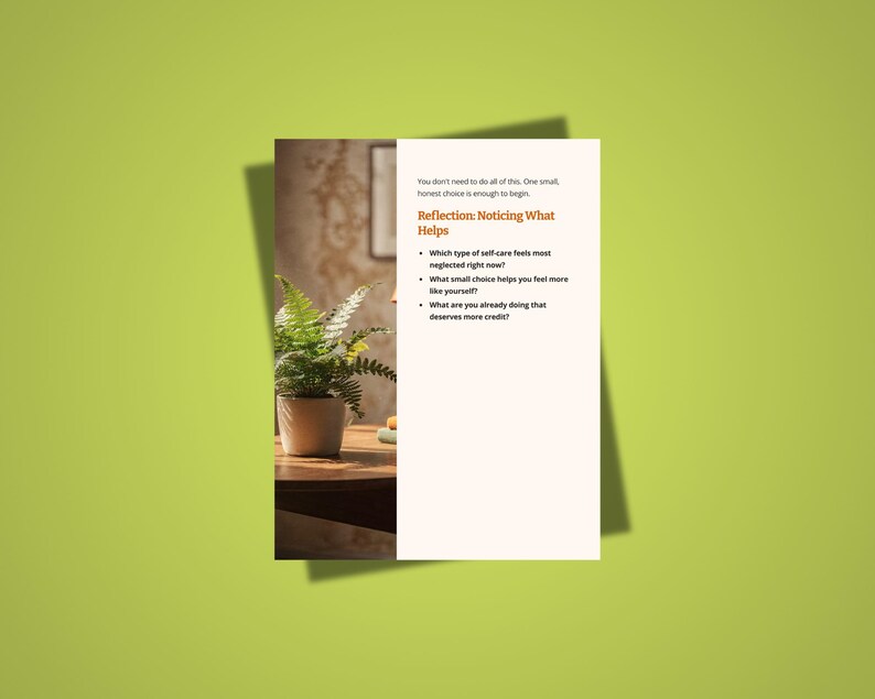 May include: A white card with text on a green background. The text reads "Reflection: Noticing What Helps" and lists questions about self-care. A potted fern sits on a wooden table, with a blurred background.