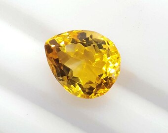 May include: A faceted, pear-shaped gemstone with a vibrant yellow hue. The gem is cut to maximize light reflection, showcasing its clarity and brilliance. The stone is set against a white background, highlighting its color and shape. This gemstone is suitable for jewelry.