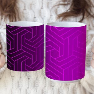 May include: Two ceramic mugs featuring a geometric pattern of interlocking lines. The left mug has a dark purple background with bright magenta lines, while the right mug has a vibrant magenta background with darker purple lines and white interiors.