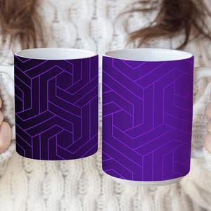 May include: Two ceramic mugs featuring a geometric pattern of interlocking lines in shades of purple. The left mug displays a dark purple gradient, while the right mug features a lighter, vibrant purple tone. Both mugs have white interiors and handles.