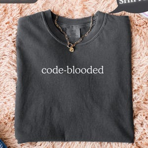 May include: A set of three ceramic mugs with a speckled, matte finish. The mugs are in shades of cream, light gray, and dark gray. Each mug has a simple, minimalist design, perfect for coffee or tea.