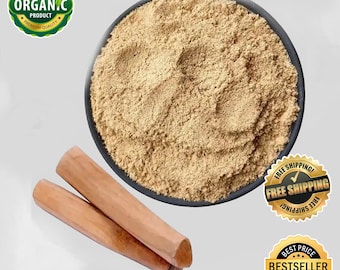 May include: A close-up of a bowl filled with light brown sandalwood powder. Two pieces of sandalwood are positioned below the bowl. The text "Pure Sandalwood Powder" is at the top. The text "HERBS BY SEGA" is at the bottom.