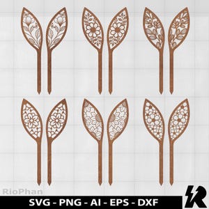 May include: Six pairs of wooden bunny ear-shaped cutouts with intricate floral and leaf designs. Each cutout features a detailed pattern, including flowers, leaves, and other botanical elements. The cutouts are brown and have a stake at the bottom.