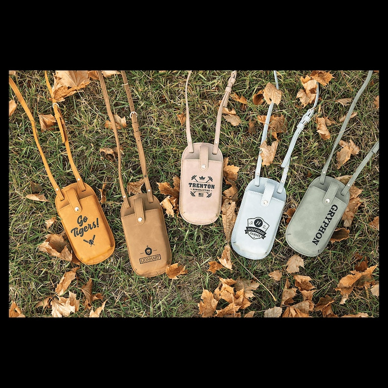 May include: Five leather phone cases with adjustable straps in various colors: yellow, brown, beige, light blue, and gray. Each case features a different logo or text, including "Go Tigers!" and "Gryphon."