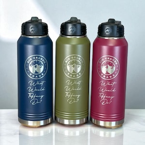 Three insulated water bottles in navy blue, olive green, and maroon stand side by side on a white surface, each engraved with a circular logo reading Rio Grande Trade and the phrase What Would Tiffany Do?