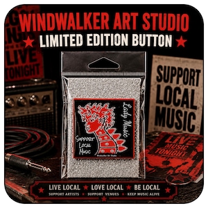 May include: A square pin-back button featuring a red graphic of a person with spiky hair and a spiked collar on a black background. The text reads Lady Music and Support Local Music. The button is packaged in a clear plastic bag with silver glitter.