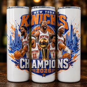 May include: A white cylindrical tumbler featuring a graphic of basketball players in New York Knicks jerseys, a gold championship trophy, the New York City skyline, and the text New York Knicks Champions 2026 in blue and orange colors.