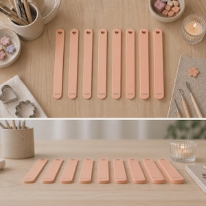 Peut inclure: Dix outils de modelage pêche avec des découpes en forme de cœur, allant de 2 mm à 6 mm. Ils sont disposés sur une surface en bois clair, avec d'autres fournitures de bricolage visibles.
