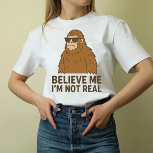 Funny Bigfoot PNG | &quot;Believe Me I&#39;m Not Real&quot; Sasquatch Digital Download | Cryptid Humor Clipart for T-Shirts & Mugs