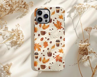 May include: A phone case with a cream background featuring a repeating pattern of autumn leaves, coffee cups, coffee beans, and cartoon ghosts holding coffee cups. The case has a camera cutout and a glossy finish.