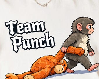 May include: White t-shirt with the text "Team Punch" in a black and white font. The shirt features a cartoon illustration of a grey monkey pulling an orange plush toy. The plush toy is lying on the ground.