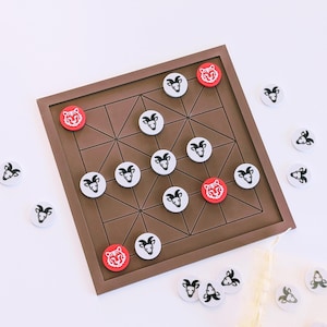 May include: A brown wooden board game with a geometric design. The game includes white and red circular game pieces with animal illustrations. Some pieces are on the board, while others are scattered around it.