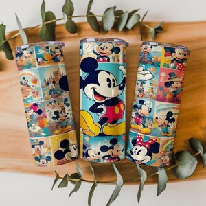 May include: Three cylindrical metal tumblers with lids, each featuring a colorful collage of Mickey Mouse and Minnie Mouse illustrations. The designs include various poses of the characters in vibrant shades of red, yellow, blue, and pink.
