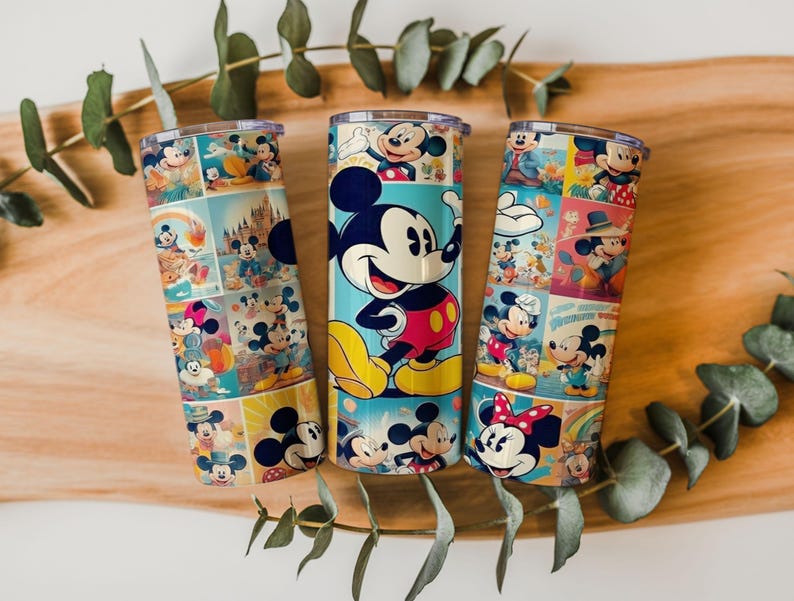 May include: Three cylindrical metal tumblers with lids, each featuring a colorful collage of Mickey Mouse and Minnie Mouse illustrations. The designs include various poses of the characters in vibrant shades of red, yellow, blue, and pink.