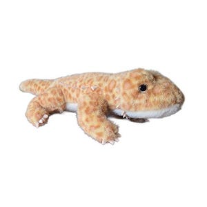 May include: A soft toy gecko, featuring a tan and orange spotted pattern, with a white underside. The plush reptile has small black eyes and detailed claws. The toy is designed to resemble a leopard gecko.
