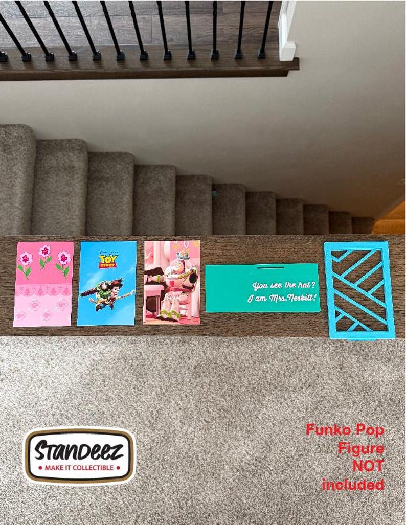 May include: A collection of colorful cards and a blue geometric cutout are displayed on a wooden surface. The cards feature floral designs, Toy Story characters, and the text "You see the hat? I am Mrs. Nesbitt!" A "Standeez" sticker is also present.