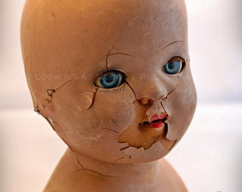 blue eyed doll art photo, broken doll, outsider art that might be a little creepy or scary, creepy doll head for Halloween